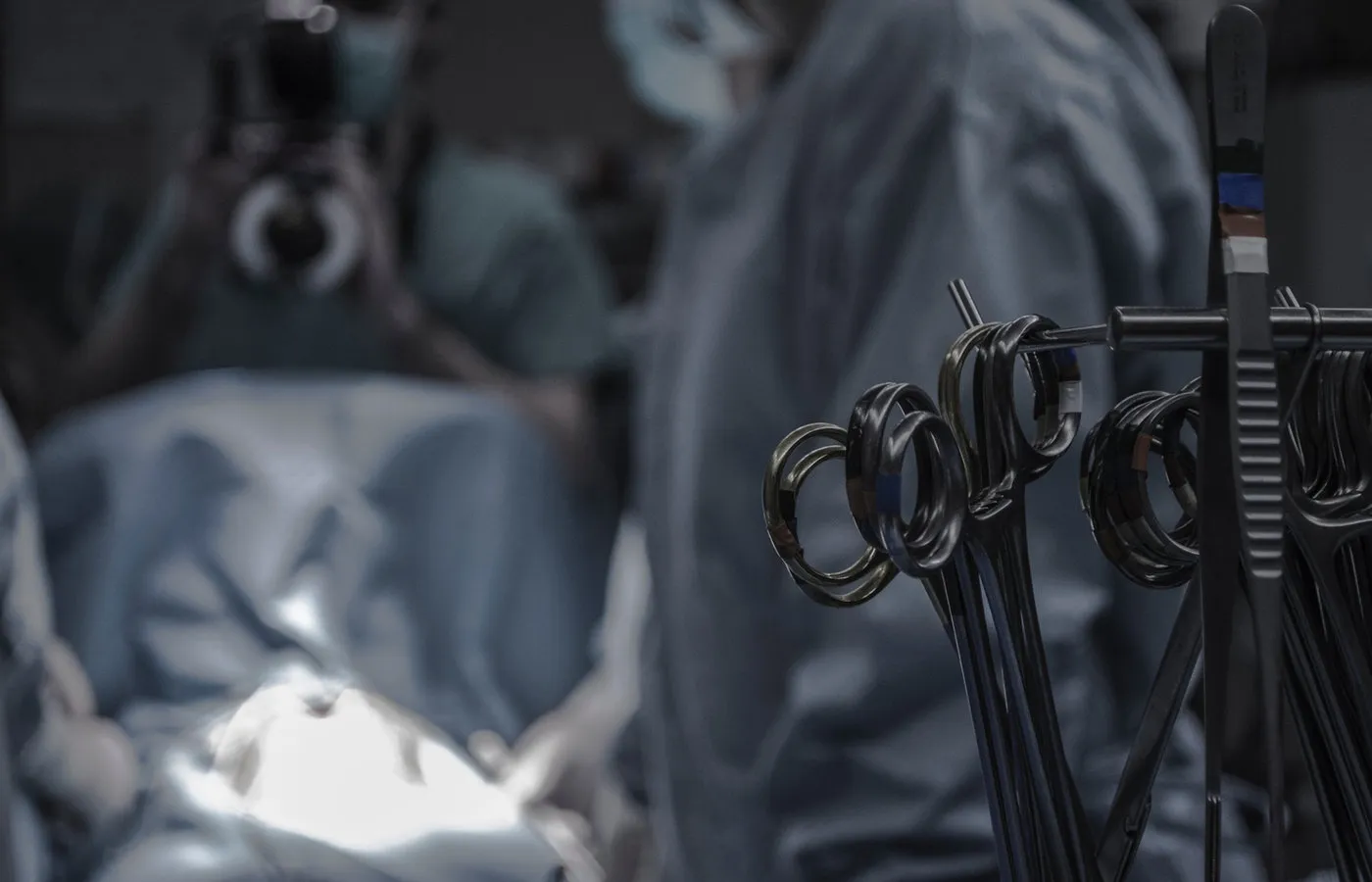 Surgical instruments arranged on a sterile tray in an operating theatre.
